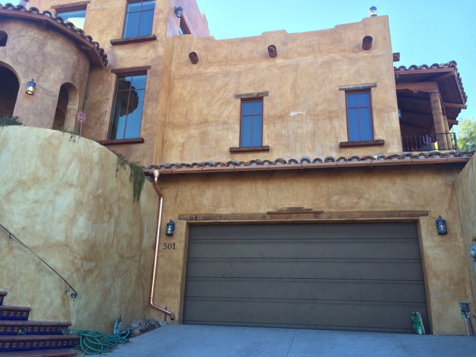 City Seamless half-round rain gutter with downspout routing on a custom home.