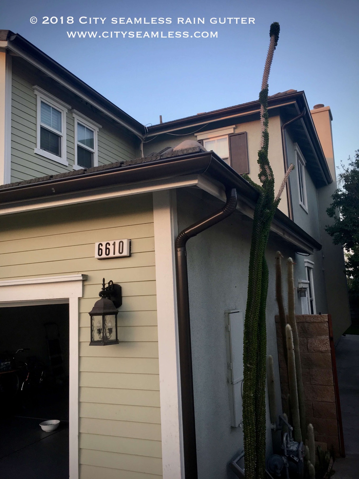 City Seamless half-round rain gutter with downspout routing on a custom home.