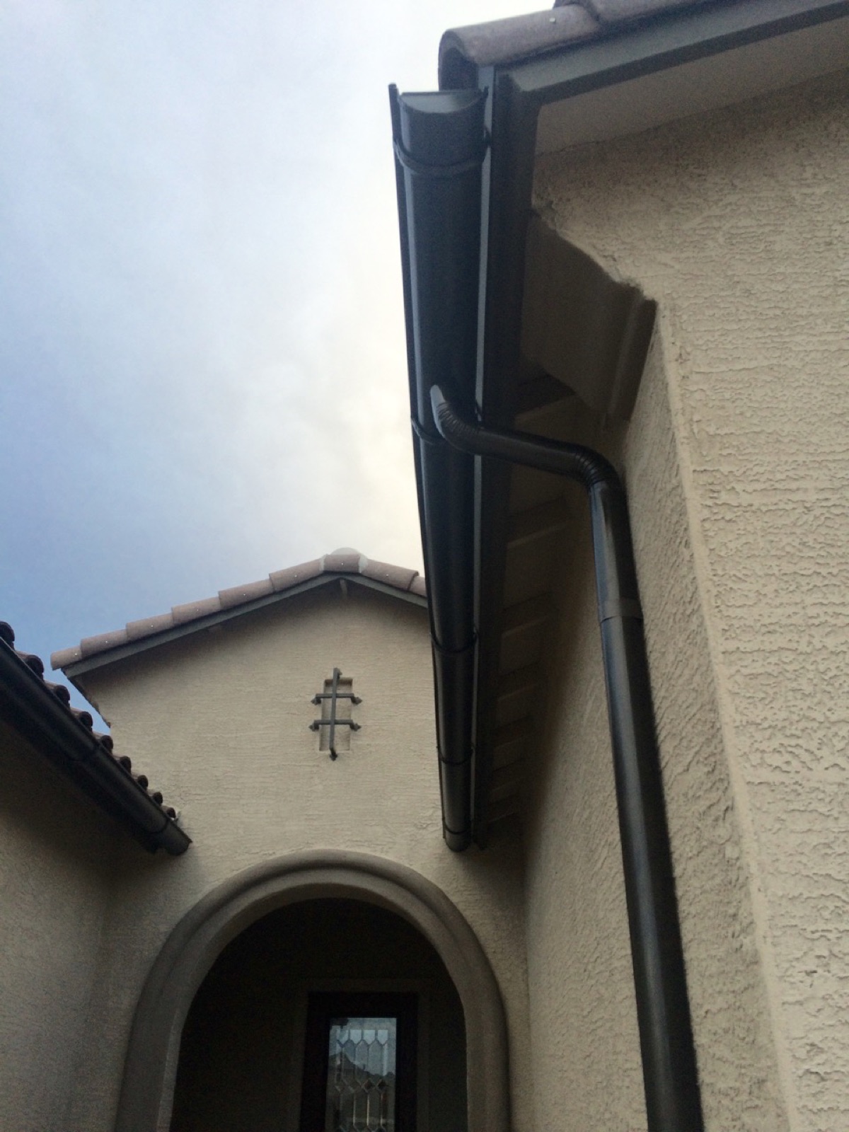 City Seamless half-round rain gutter with downspout routing on a custom home.