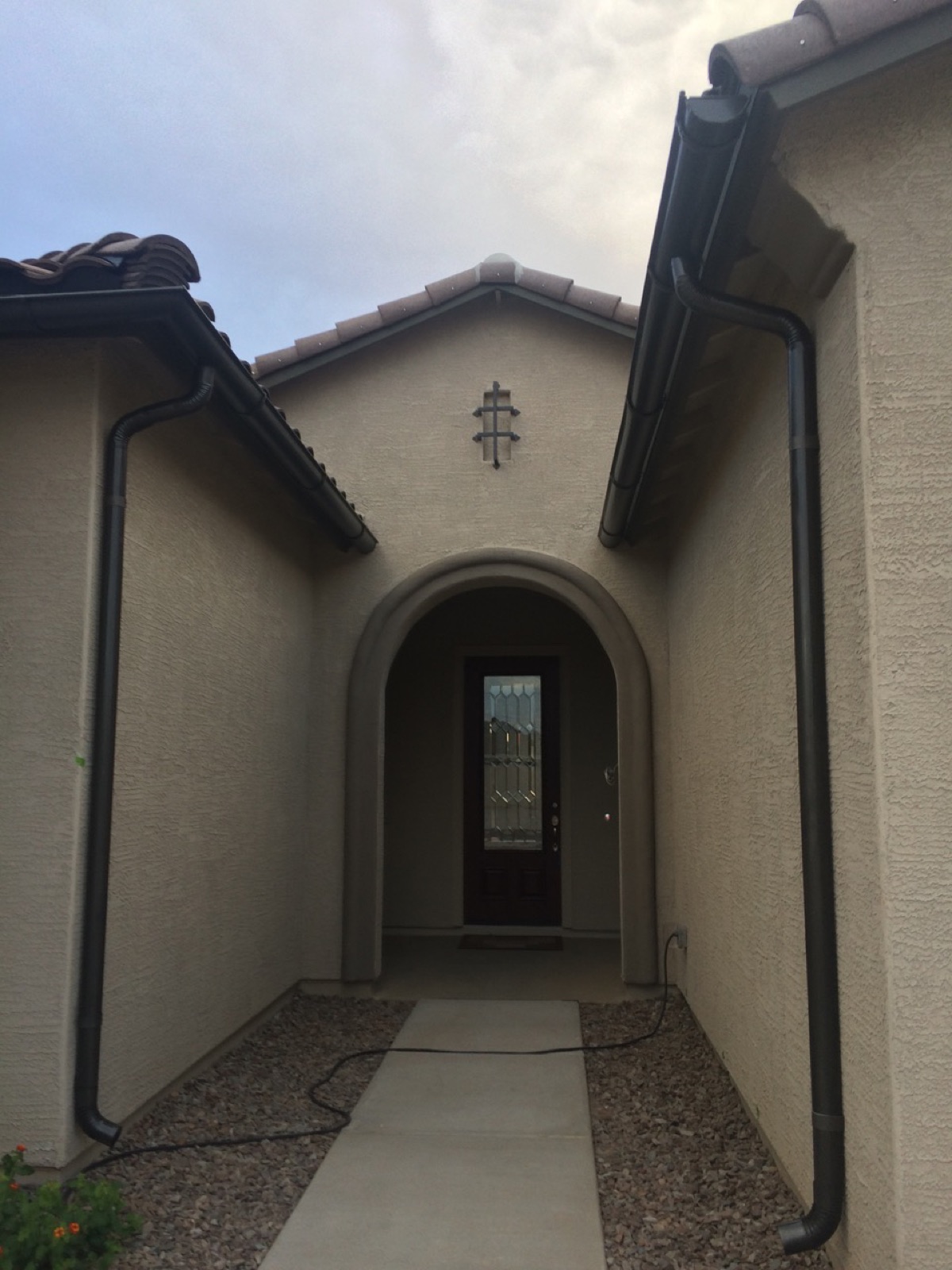 City Seamless half-round rain gutter with downspout routing on a custom home.