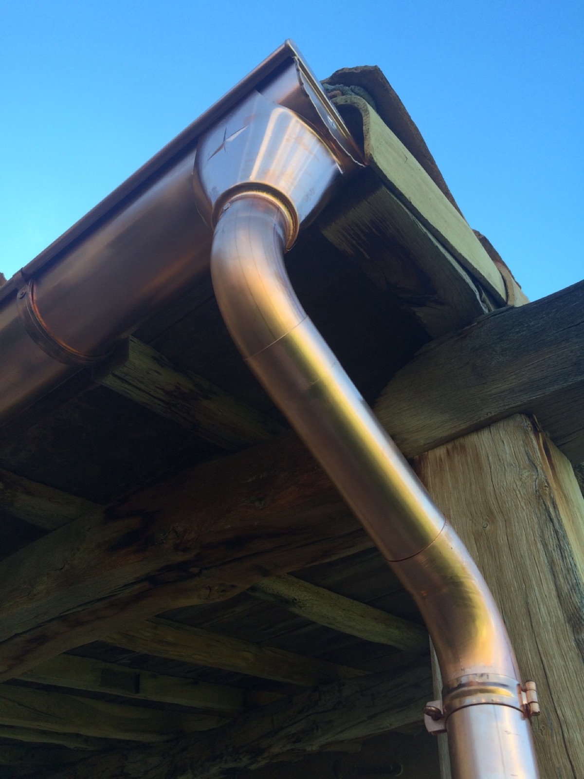 City Seamless half-round rain gutter with downspout routing on a custom home.