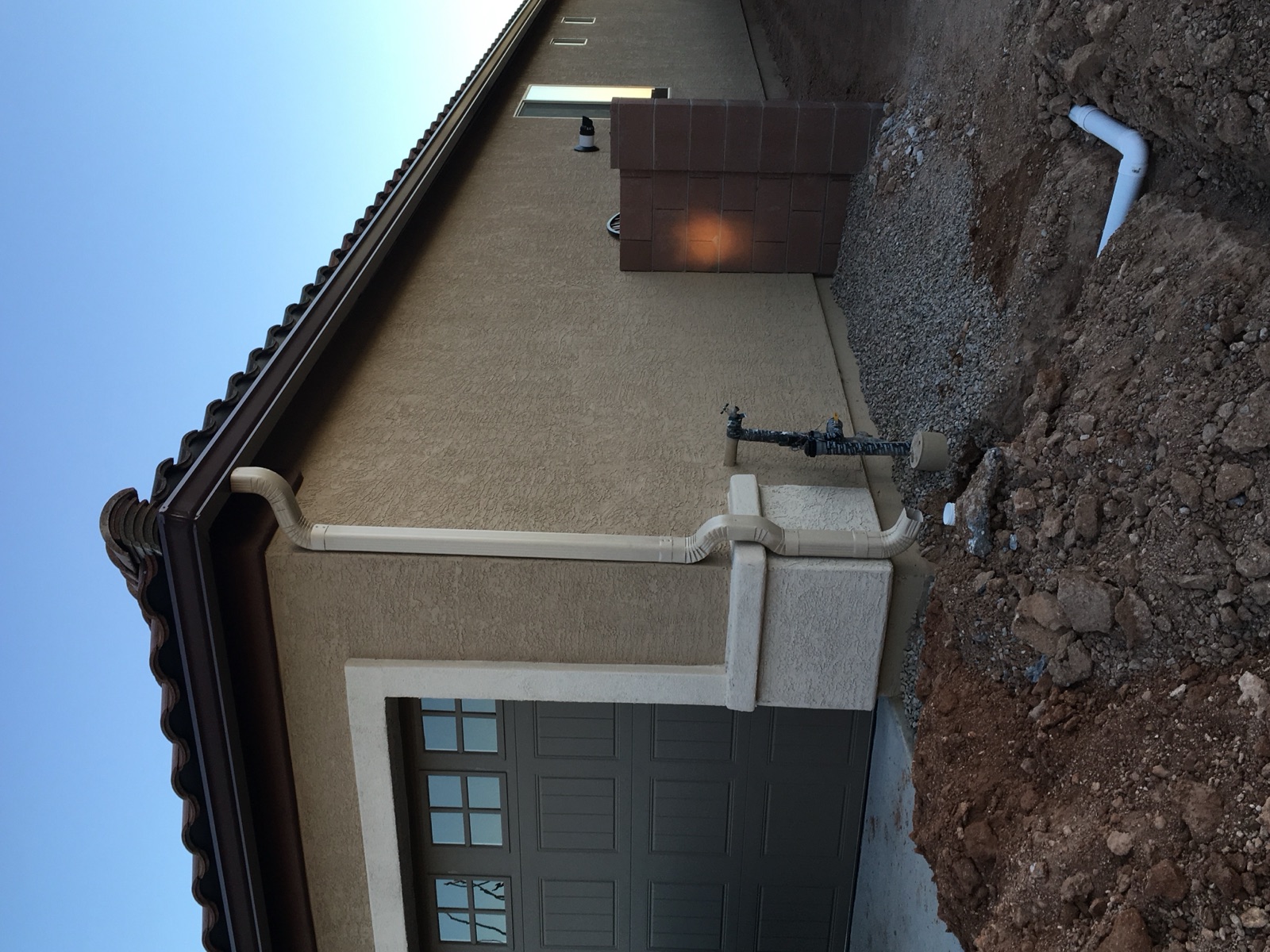 City Seamless K-style seamless rain gutter with downspout routing on a Southern Nevada home.