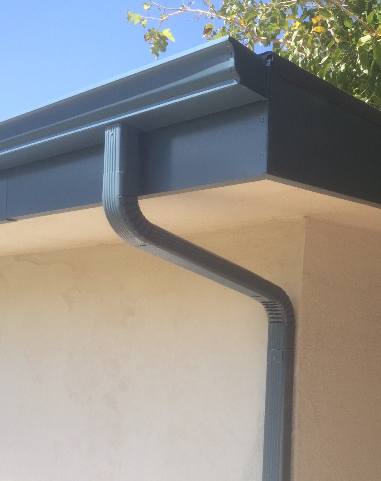 City Seamless K-style seamless rain gutter with downspout routing on a Southern Nevada home.