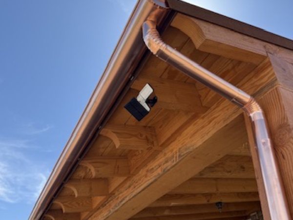 City Seamless half-round rain gutter with downspout routing on a custom home.