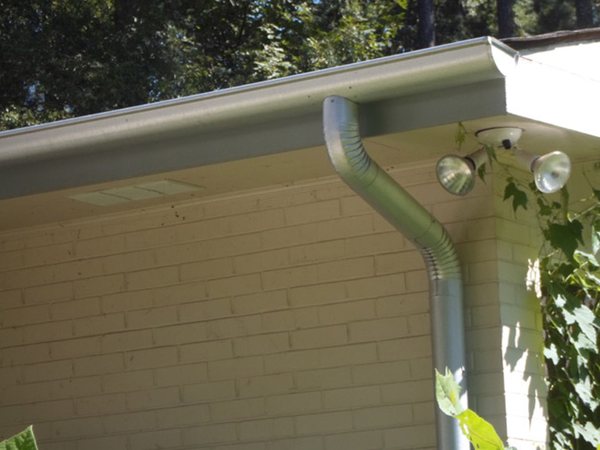 City Seamless half-round rain gutter with downspout routing on a custom home.