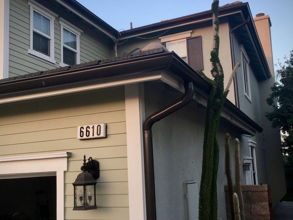 City Seamless half-round rain gutter with downspout routing on a custom home.