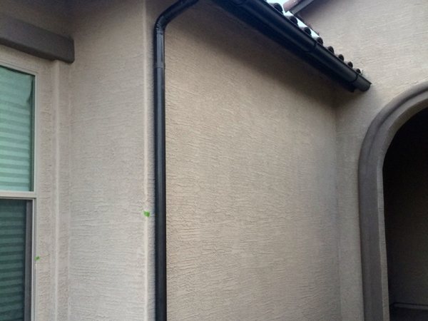 City Seamless half-round rain gutter with downspout routing on a custom home.