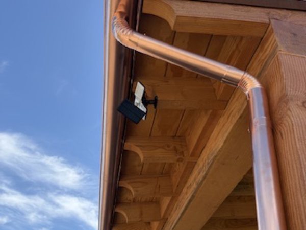 City Seamless half-round rain gutter with downspout routing on a custom home.