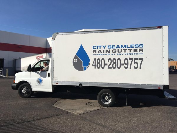 City Seamless rain gutter installation crew and equipment photo.