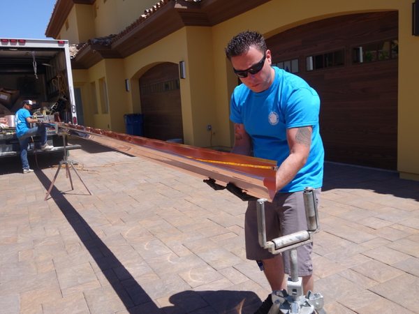 City Seamless rain gutter installation crew and equipment photo.