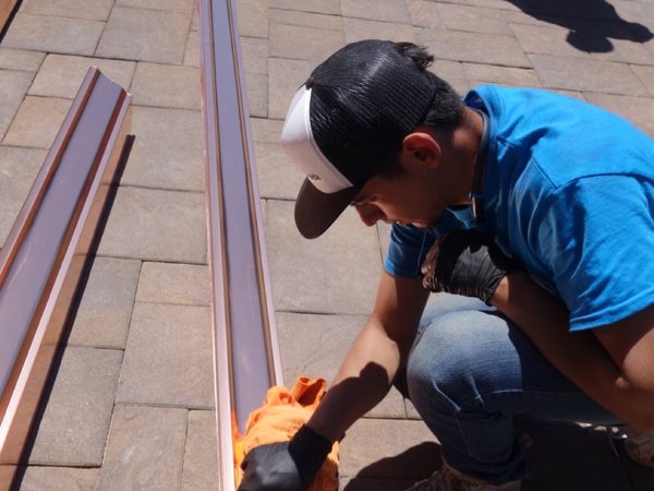 City Seamless rain gutter installation crew and equipment photo.
